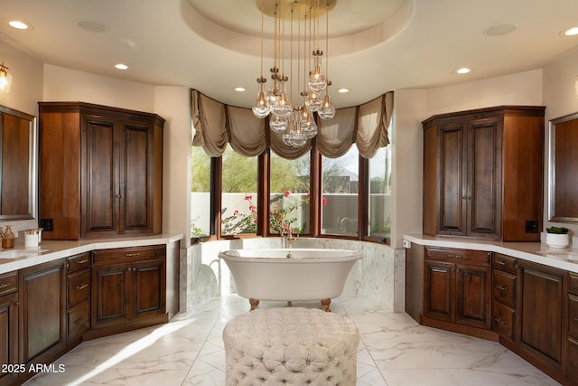 full bath featuring a freestanding tub, recessed lighting, and marble finish floor