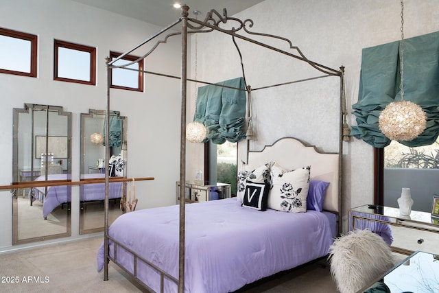 bedroom with carpet and a towering ceiling