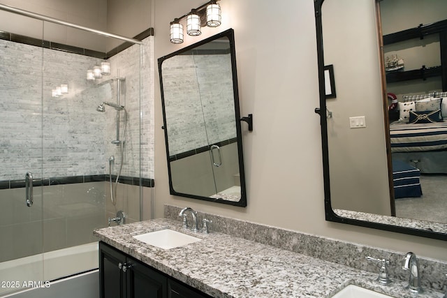 full bath featuring vanity and bath / shower combo with glass door