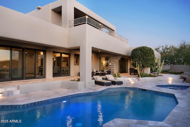 view of swimming pool with outdoor dining area, a sink, a patio, a fenced in pool, and an in ground hot tub