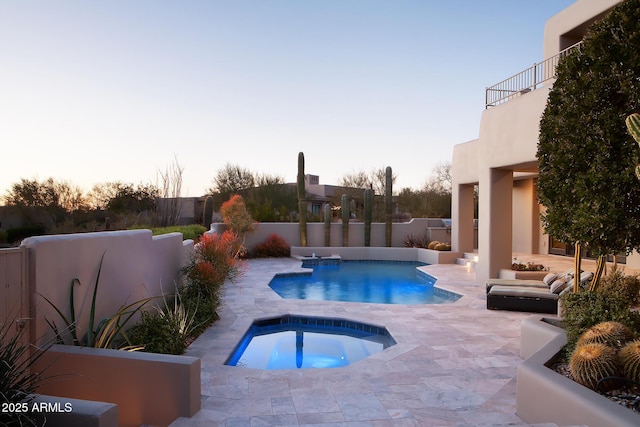 view of pool with a fenced backyard, a fenced in pool, an in ground hot tub, and a patio