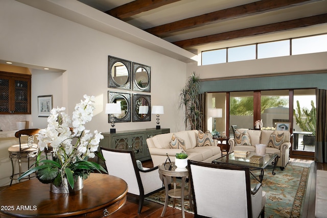 living area featuring beamed ceiling