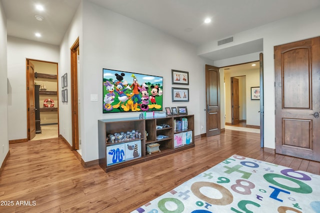 interior space featuring recessed lighting, visible vents, baseboards, and hardwood / wood-style flooring