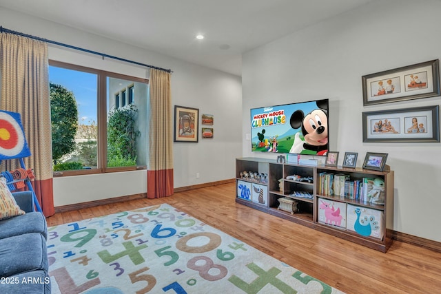 interior space with recessed lighting, wood finished floors, and baseboards