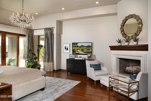 bedroom featuring hardwood / wood-style floors, recessed lighting, a fireplace, and french doors