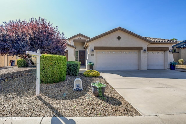 1527 Bainbridge Ln, Chino Valley, AZ 86323 - view of front facade with an attached garage, concrete driveway, stucco siding, and a tiled roof