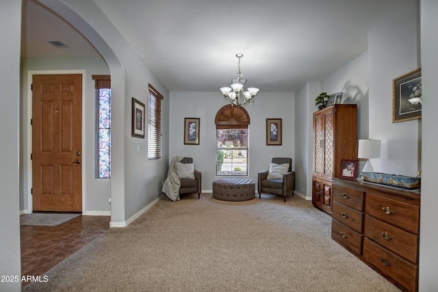 1527 Bainbridge Ln, Chino Valley, AZ 86323 - sitting room featuring a chandelier, arched walkways, carpet flooring, and baseboards