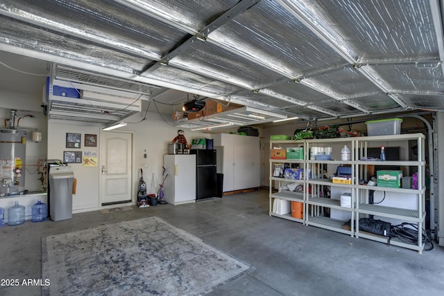 1527 Bainbridge Ln, Chino Valley, AZ 86323 - garage featuring strapped water heater, freestanding refrigerator, and a garage door opener