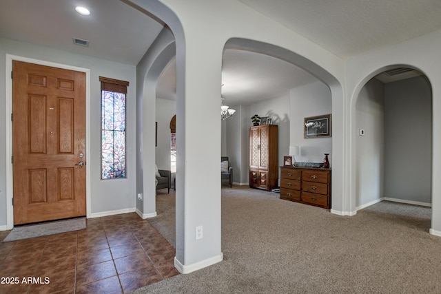 1527 Bainbridge Ln, Chino Valley, AZ 86323 - entrance foyer with baseboards, dark colored carpet, and arched walkways