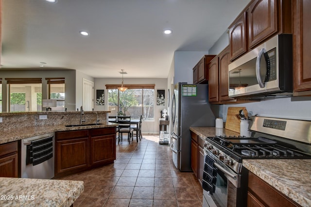 1527 Bainbridge Ln, Chino Valley, AZ 86323 - kitchen with stainless steel appliances, a sink, recessed lighting, decorative light fixtures, and light stone countertops