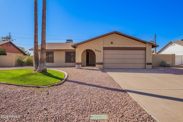 ranch-style house featuring an attached garage, fence, concrete driveway, and stucco siding