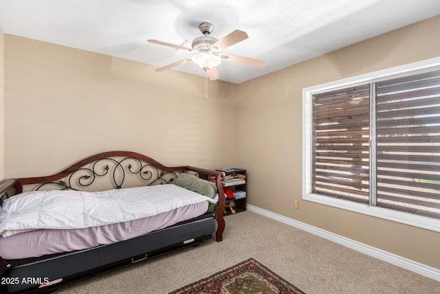 carpeted bedroom featuring ceiling fan and baseboards