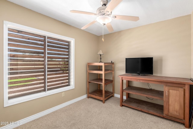 office with a ceiling fan, light colored carpet, and baseboards