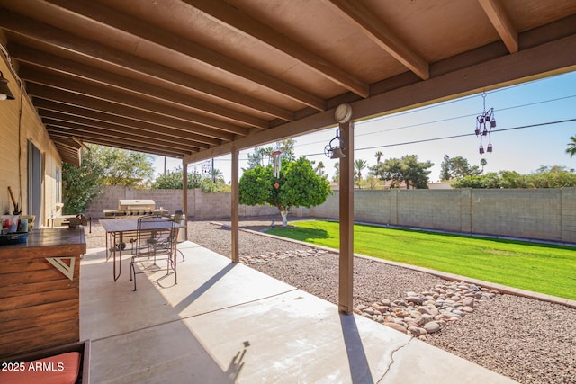 view of patio with outdoor dining space and a fenced backyard