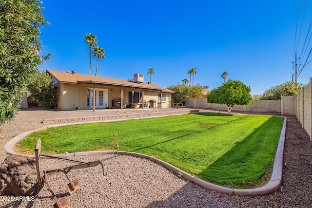 rear view of property with a patio area, a fenced backyard, a lawn, and stucco siding