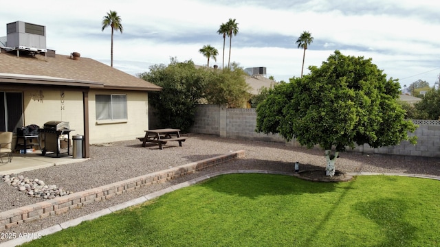 view of yard featuring central AC unit, a patio area, and a fenced backyard