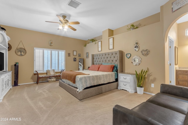 carpeted bedroom featuring ceiling fan and connected bathroom