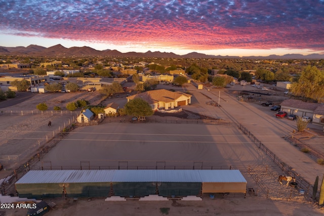 aerial view at dusk featuring a mountain view