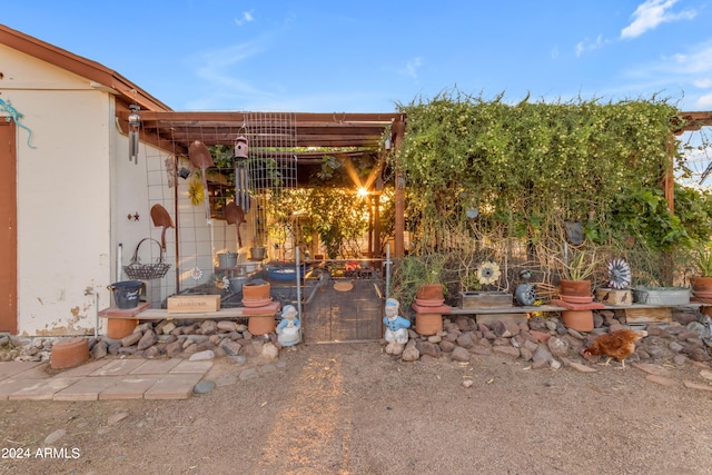 doorway to property with a pergola