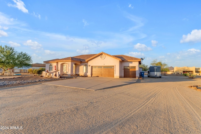 mediterranean / spanish-style home featuring a garage