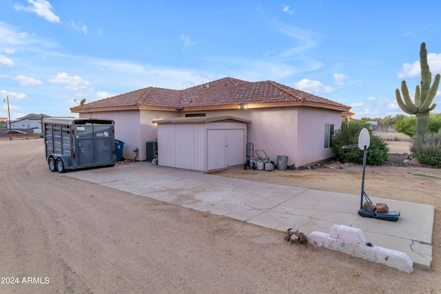 view of side of property with a shed