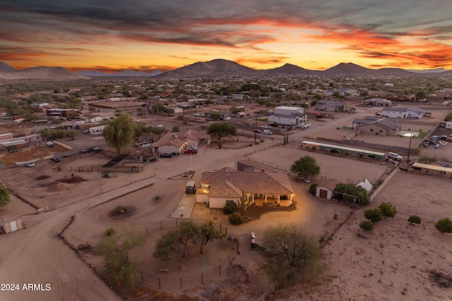 aerial view at dusk featuring a mountain view