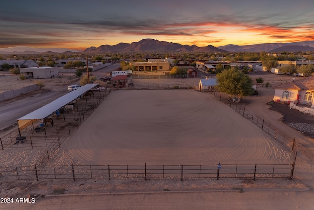 aerial view at dusk featuring a mountain view