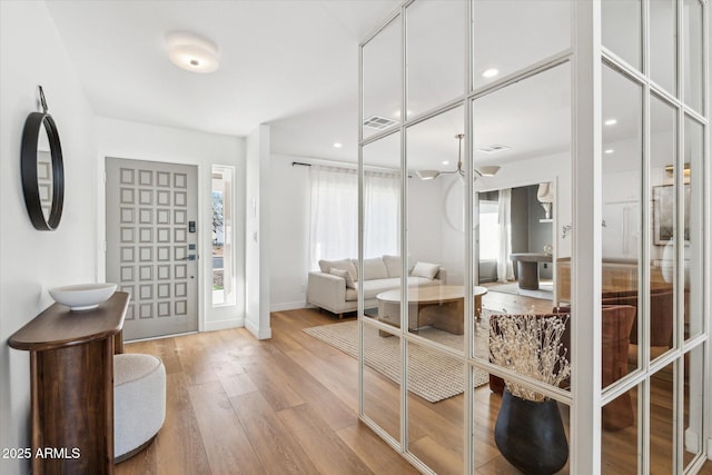 entrance foyer featuring recessed lighting, visible vents, baseboards, and wood finished floors