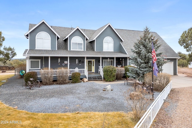 view of front of house featuring covered porch and a garage