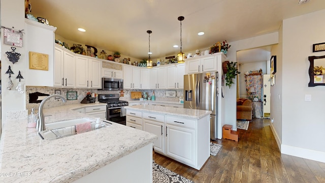 kitchen featuring white cabinets, backsplash, and stainless steel appliances