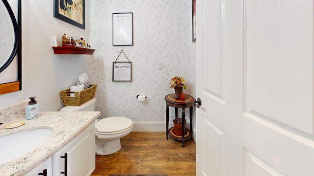 bathroom featuring toilet, hardwood / wood-style floors, and vanity