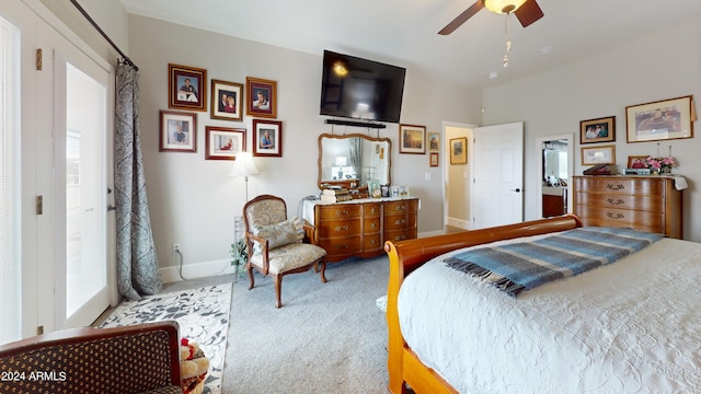 bedroom featuring light colored carpet, multiple windows, and ceiling fan