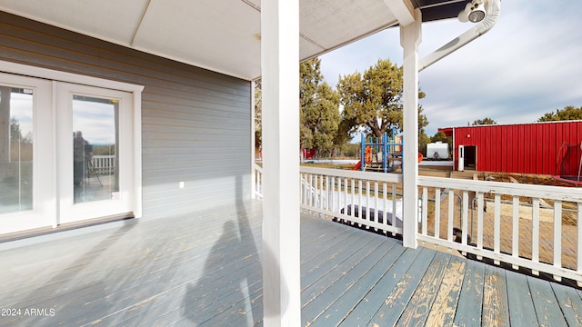 wooden terrace with a playground