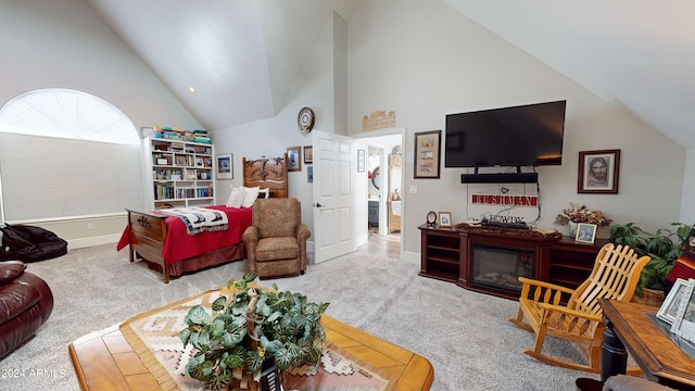 living room featuring high vaulted ceiling and light colored carpet