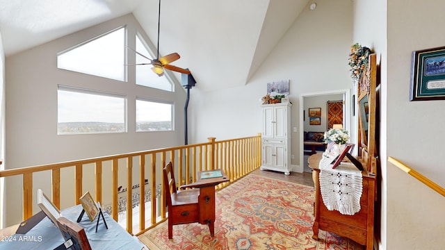 hall with high vaulted ceiling and light hardwood / wood-style flooring