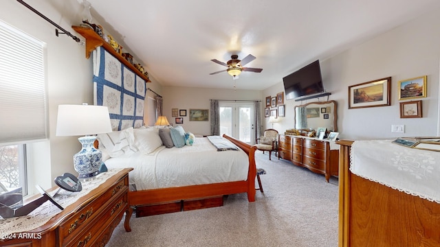 bedroom with light carpet, ceiling fan, and french doors