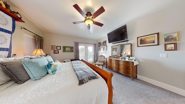 carpeted bedroom with french doors and ceiling fan