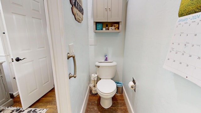 bathroom with toilet and hardwood / wood-style floors