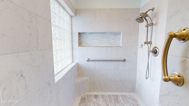 bathroom with a tile shower