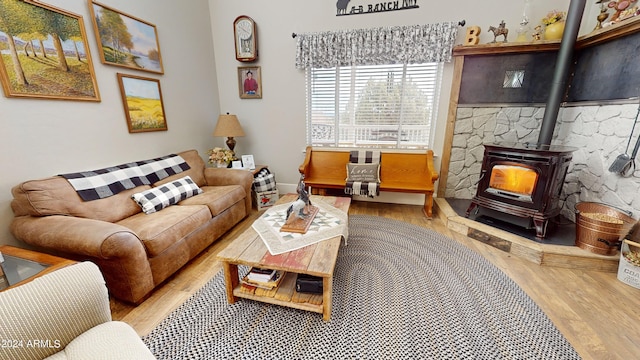 living room with light hardwood / wood-style flooring and a wood stove