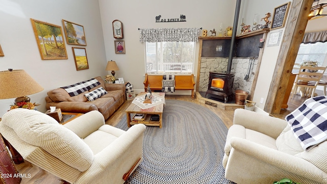 living room with a wood stove and light wood-type flooring