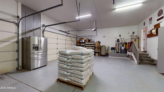 garage with stainless steel fridge with ice dispenser and water heater