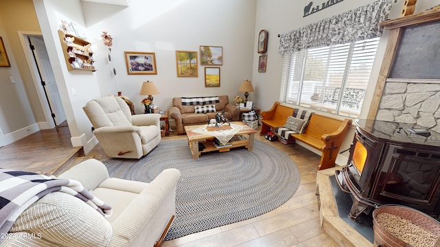 living room featuring light hardwood / wood-style flooring and a stone fireplace