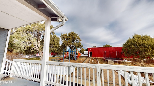 view of yard featuring a trampoline and a playground