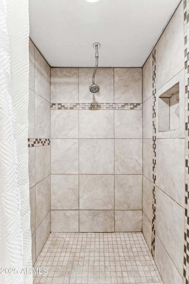 bathroom with tiled shower