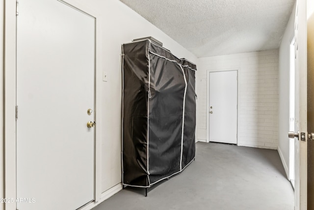 interior space with laundry area and a textured ceiling