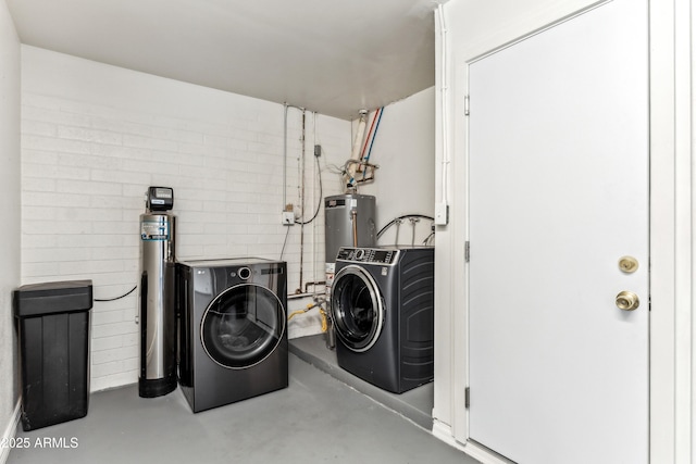 laundry room featuring gas water heater and washer and dryer