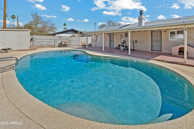 view of pool featuring a patio area, a fenced backyard, and a fenced in pool