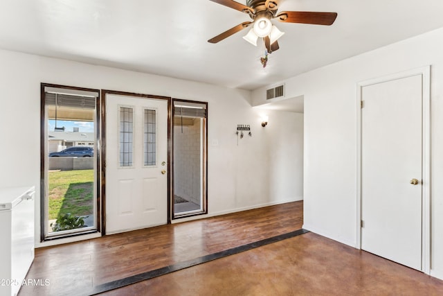 interior space with ceiling fan, visible vents, and concrete flooring