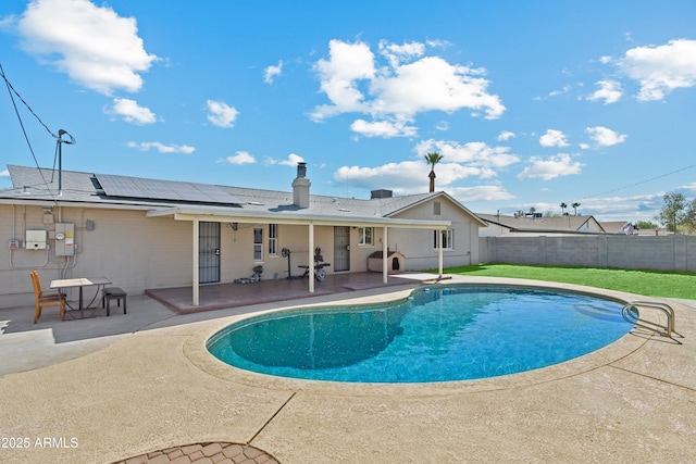 view of swimming pool with a patio, a yard, and a fenced backyard